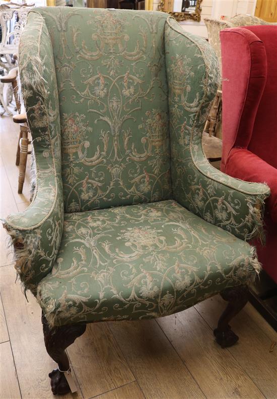 An upholstered wing armchair